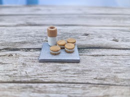 Milk and cookie on a tray very tiny!